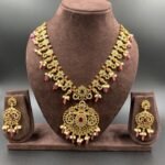 Antique necklace set with red, green, and white stones