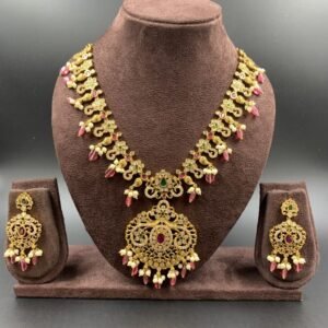 Antique necklace set with red, green, and white stones