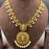 South Indian temple jewelry set featuring Lakshmi pendant and gold jhumkas with pearls