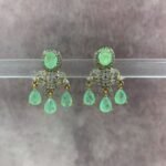 Elegant gold-toned statement earrings with red and green gemstone drops