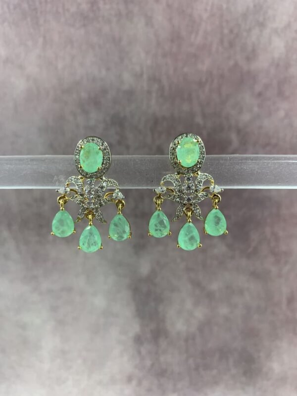 Elegant gold-toned statement earrings with red and green gemstone drops
