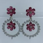 Elegant floral hoop earrings with fuchsia flower motifs and sparkling crystal accents in silver setting