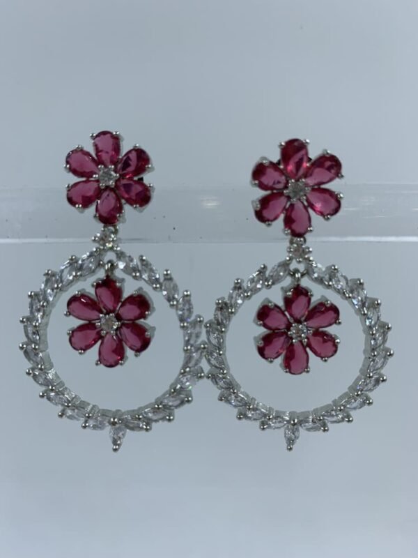 Elegant floral hoop earrings with fuchsia flower motifs and sparkling crystal accents in silver setting