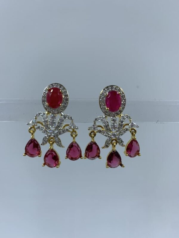 Elegant diamond earrings with chandelier design featuring oval gemstones and dangling teardrops