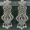 Ornate white chandelier earrings with floral design and teardrop stones