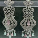 Ornate pink chandelier earrings with floral design and teardrop stones