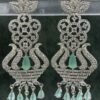 Ornate mint green chandelier earrings with floral design and teardrop stones