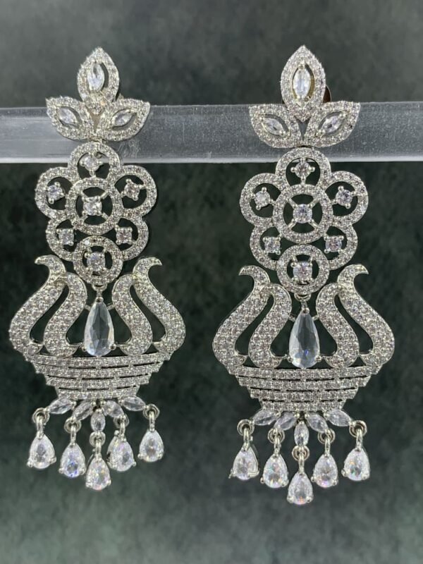 Elegant white chandelier earrings featuring white gemstones with floral accents—perfect for Indian festive and ethnic wear.