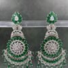 Intricate silver-toned chandbali earrings with rani and green gemstones