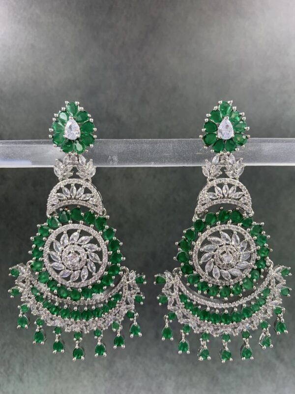 Intricate silver-toned chandbali earrings with rani and green gemstones