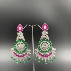 Intricate silver-toned chandbali earrings with rani and green gemstones