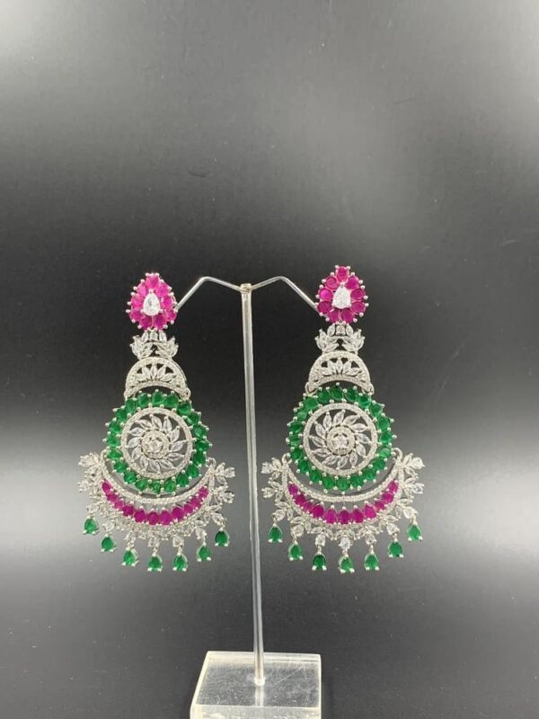 Intricate silver-toned chandbali earrings with rani and green gemstones