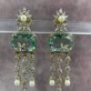 Statement drop earrings with pearl drops, mint green gemstone, and floral stud