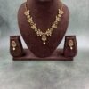 Gold-toned traditional necklace set with multicolored gemstones and pearl drop earrings