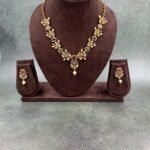 Gold-toned traditional necklace set with multicolored gemstones and pearl drop earrings