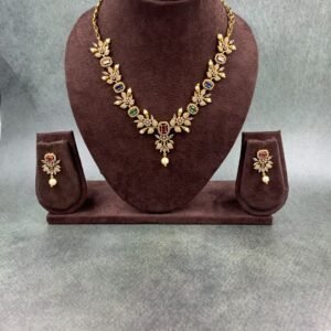 Gold-toned traditional necklace set with multicolored gemstones and pearl drop earrings