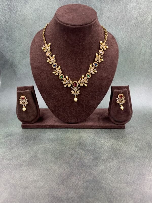 Gold-toned traditional necklace set with multicolored gemstones and pearl drop earrings
