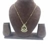 Gold-toned teardrop pendant necklace with black enamel detailing and gold bead accents