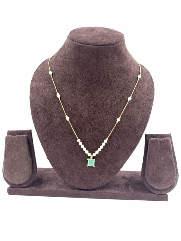Invisible chain necklace featuring a mintgreen rectangular stone and delicate white beads