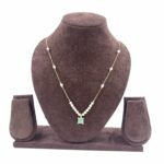 Invisible chain necklace featuring a mintgreen rectangular stone and delicate white beads