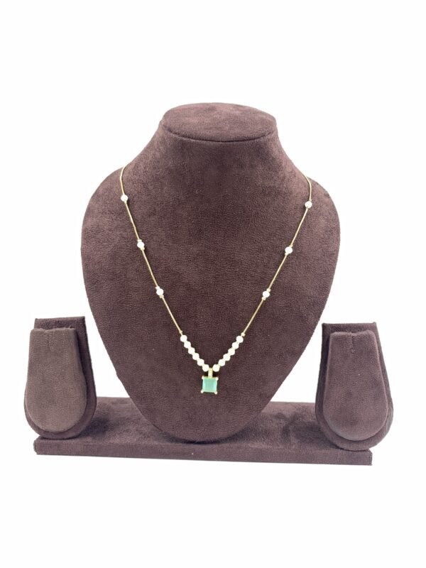 Invisible chain necklace featuring a mintgreen rectangular stone and delicate white beads